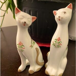 2 beautiful vintage white cats with little pink flowers painted on them.